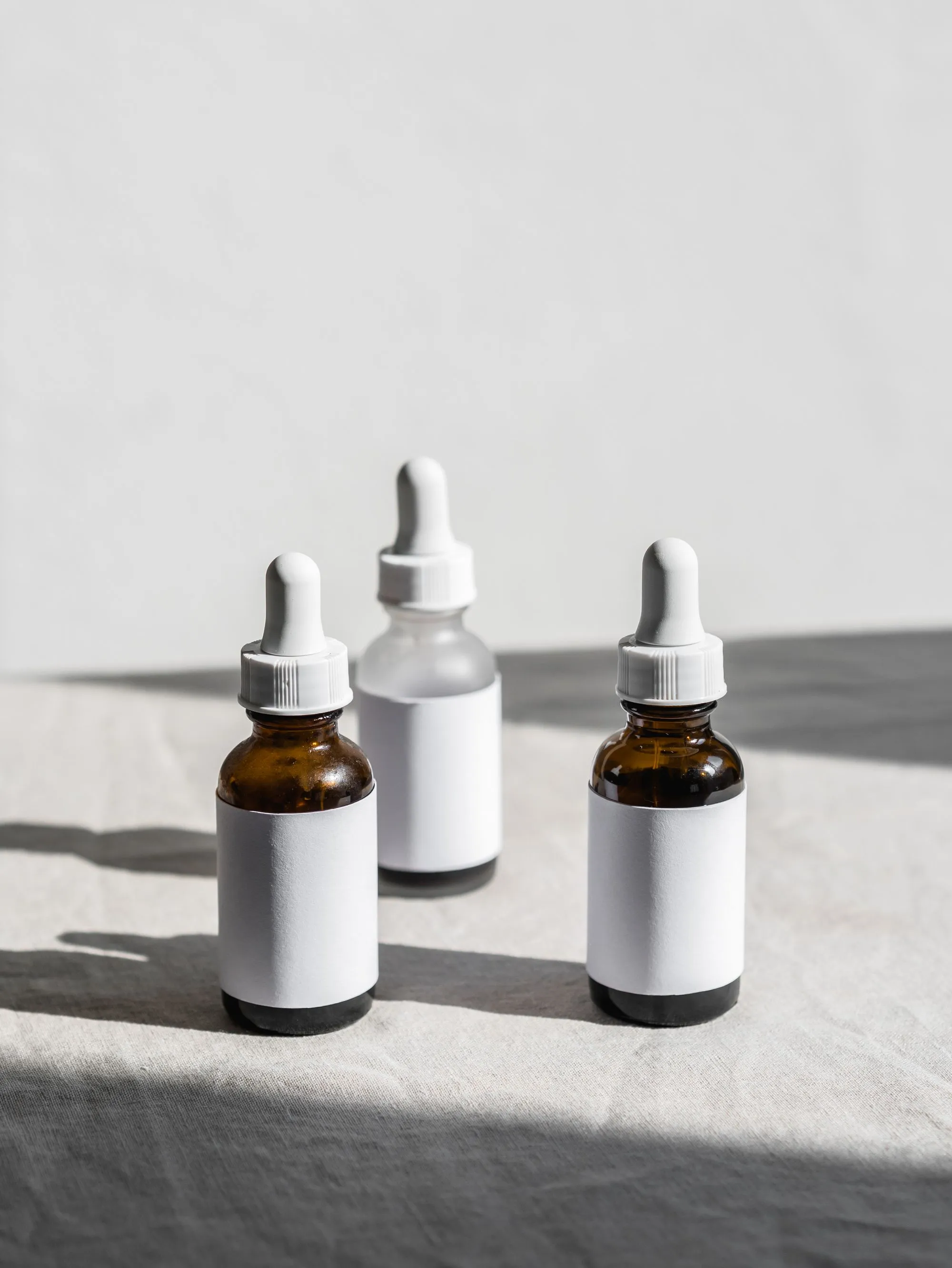 Amber serum dropper bottles in natural light