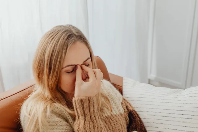 Woman at home with sinus discomfort