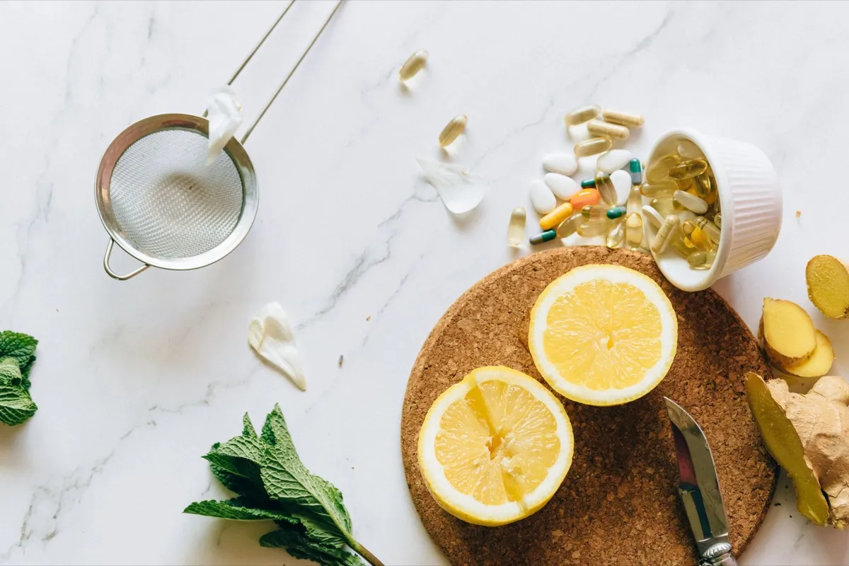 Supplements and fresh lemon on a marble counter